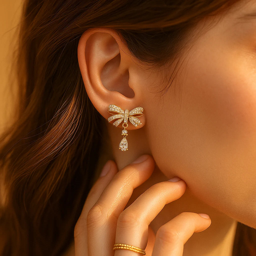 Gold-Toned Bow-Shaped Stud Earrings with Amw=erican Diamond